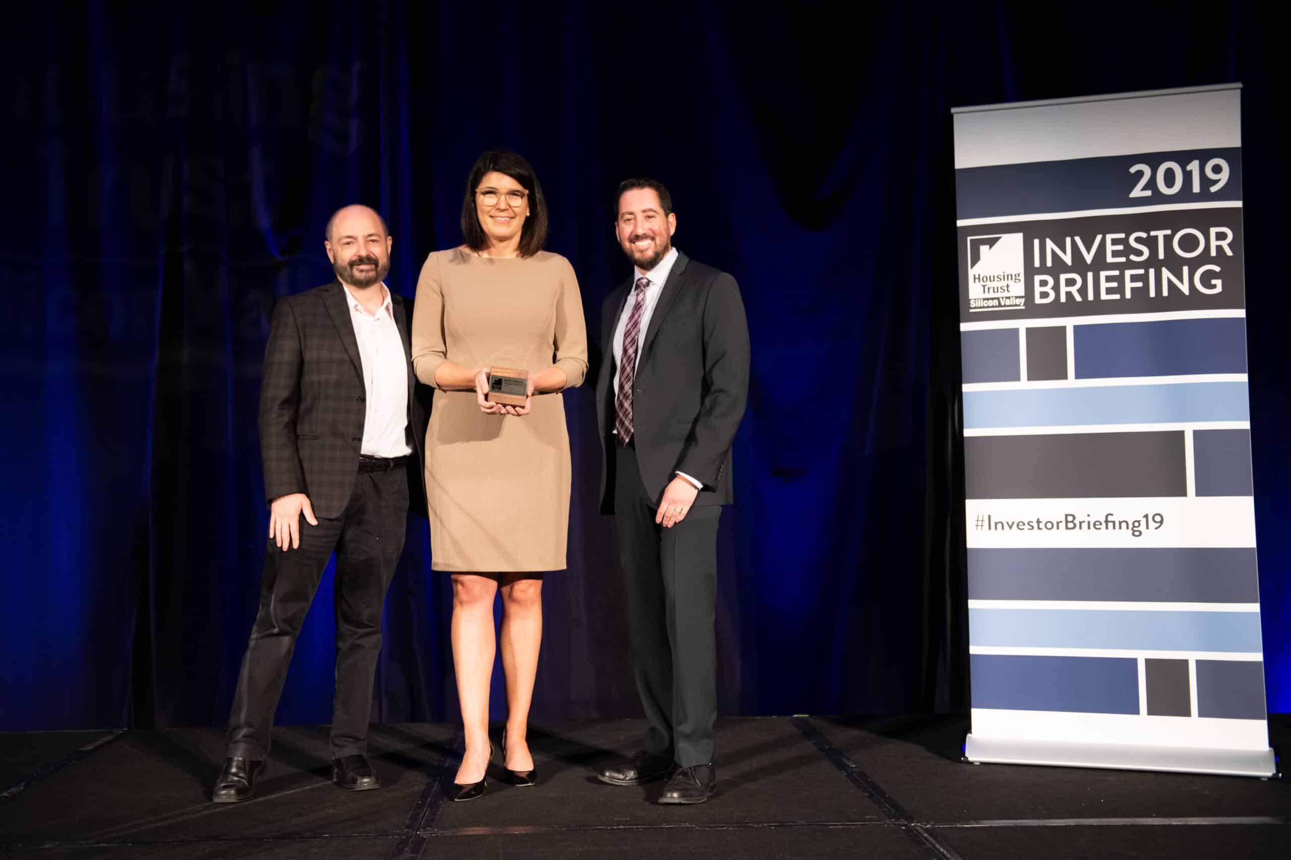 Charlie Giancarlo, CEO of Pure Storage, Katie Ferrick, Sr. Director of Workplace, Community & Environment of LinkedIn, and Kevin Zwick, CEO of Housing Trust Silicon Valley, presenting Katie with the 2019 Housing Champion Award
